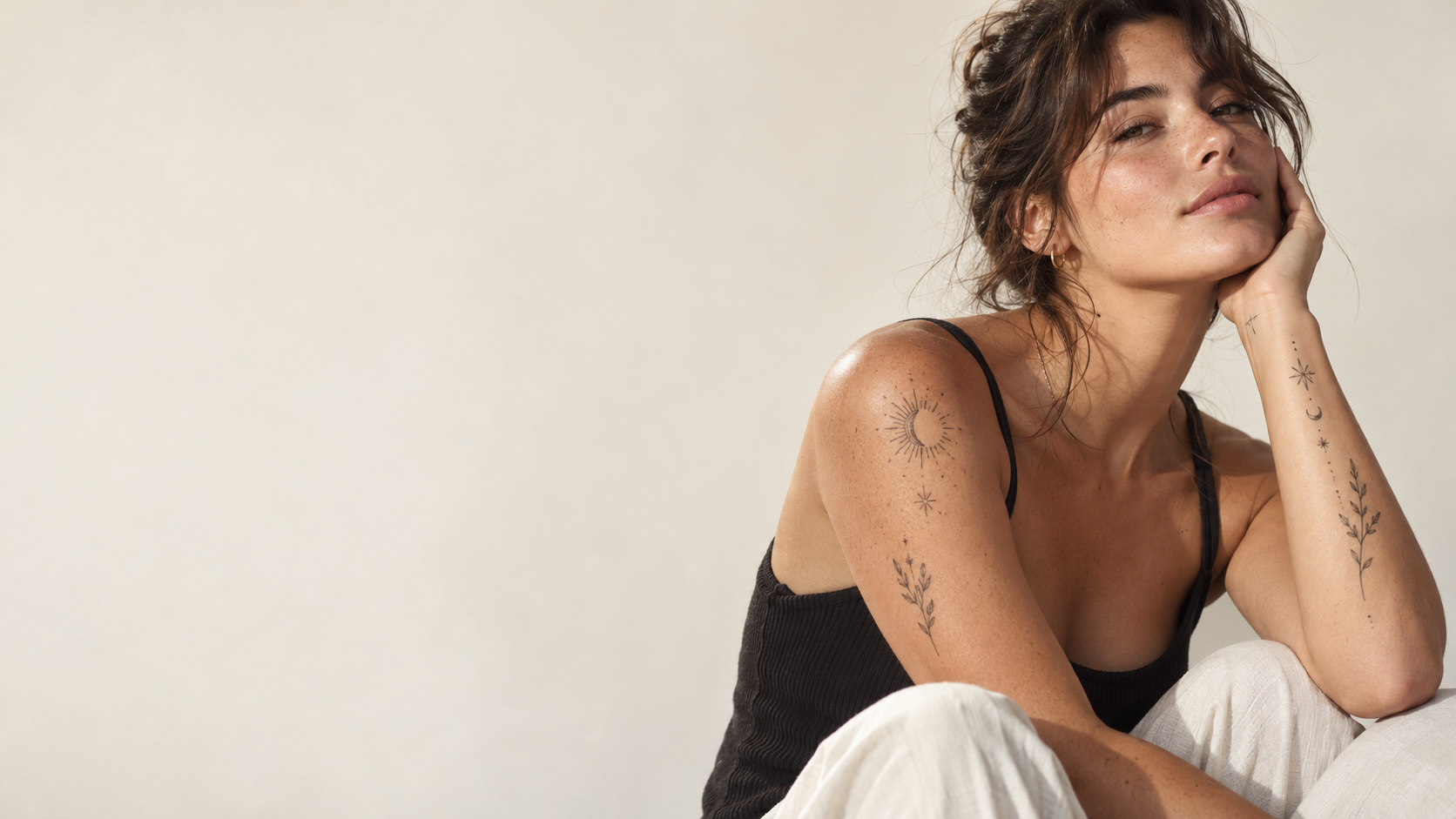 Model wearing delicate fine-line temporary tattoos